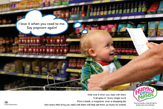 Baby in the supermarket trolley saying: I love it when you read to me. Say popcorn again!'