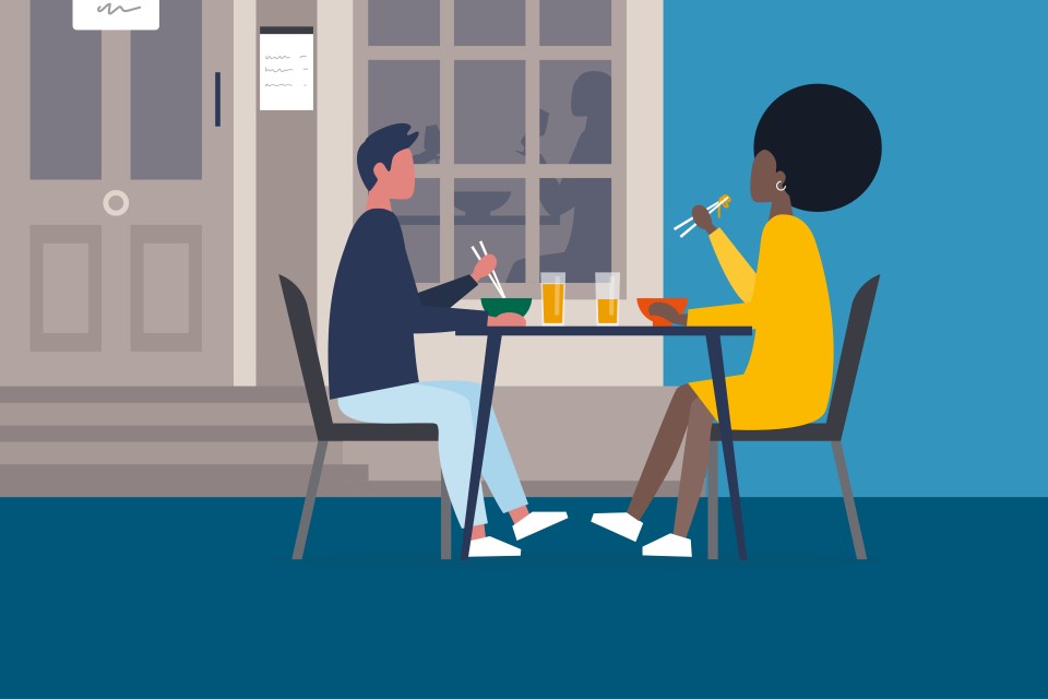 A campaign poster for the 'Here to help' campaign by the Food Standards Agency (FSA) showing two people eating and drinking at a table.