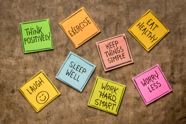 Post-its which read: 'think positively', 'exercise', 'keep things simple', 'eat healthy', 'laugh', 'sleep well', 'work smart', and 'worry less'.