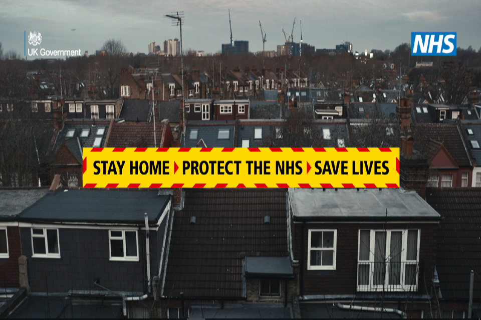 A still from the TV advert for the COVID-19 Stay At home campaign showing the tagline Stay Home, Protect the NHS, Save Lives.