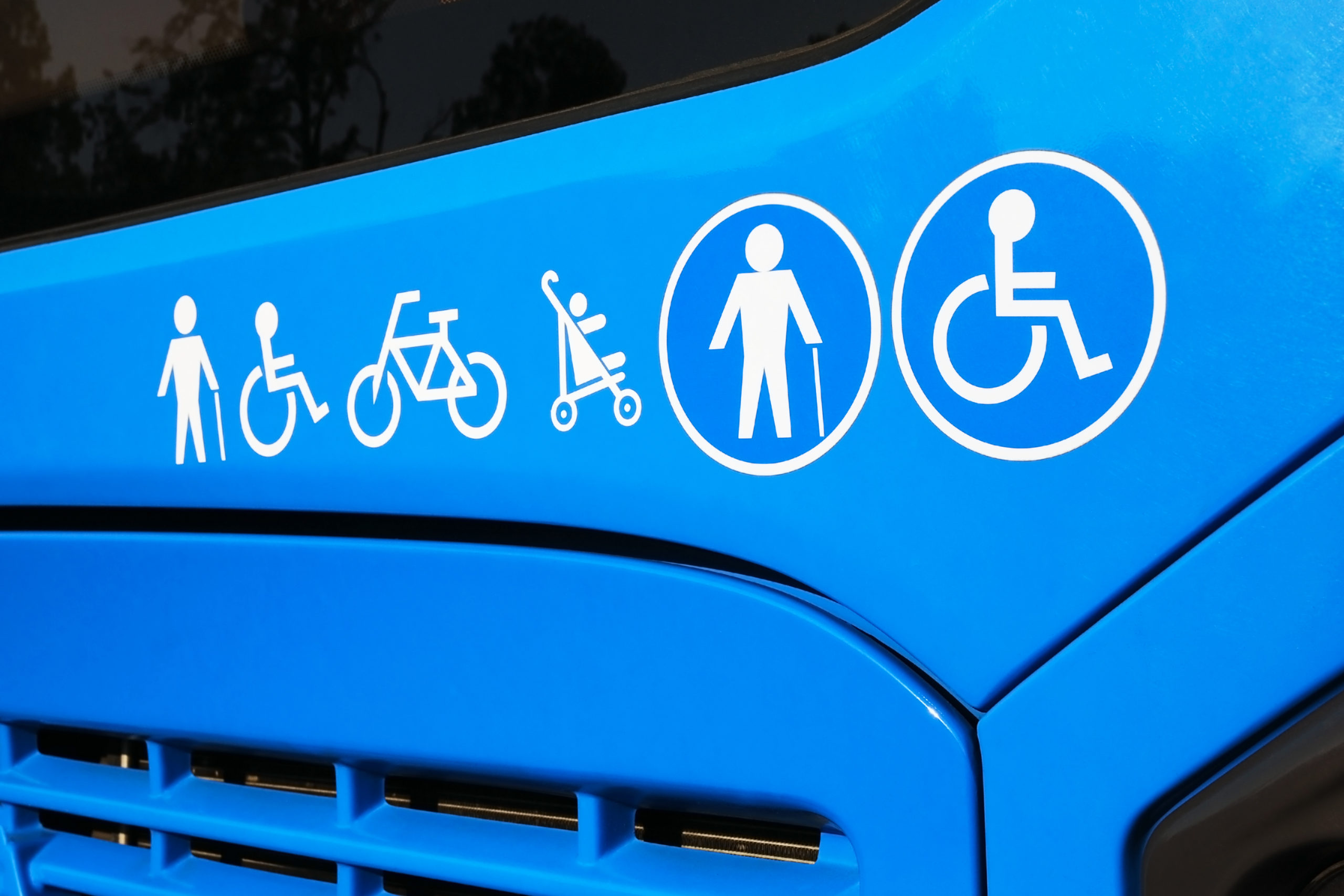A bus with logos for a wheelchair user, walking stick user, pushchair and bicycle.