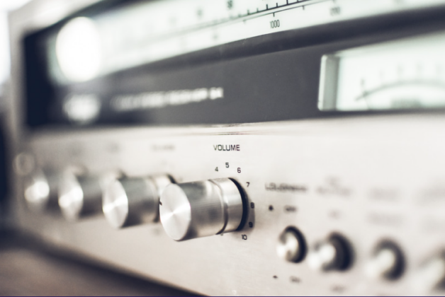 a close-up of dials on a silver stereo system e.g. volume, equaliser, metre range